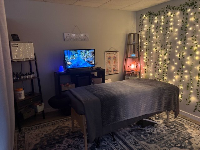 Kelly’s actual massage room with soft lights and a prepared treatment table